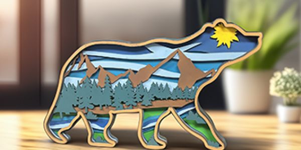 multi-layered sign of an artistic bear with mountain scene